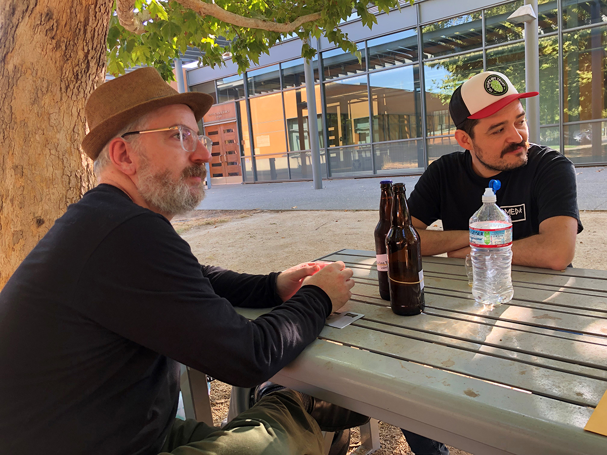 online Master Brewers grad Alex Kandel shares his homebrews with a fellow brewing classmate