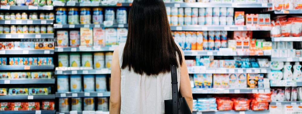 woman shopper looking at wall of products