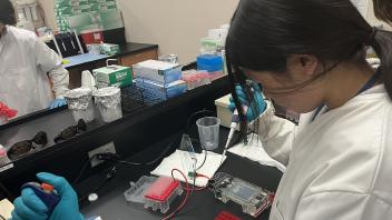 UC Davis Pre-College Program student pipetting in the Forensic lab