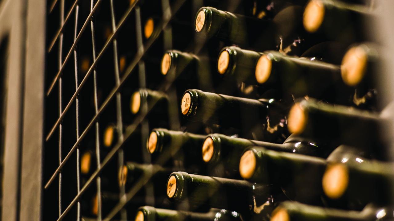 close up of wine bottles on shelf