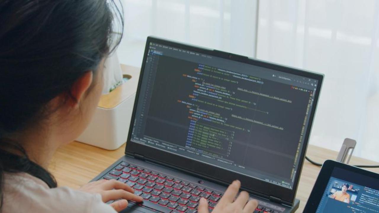 young woman working on laptop at desk