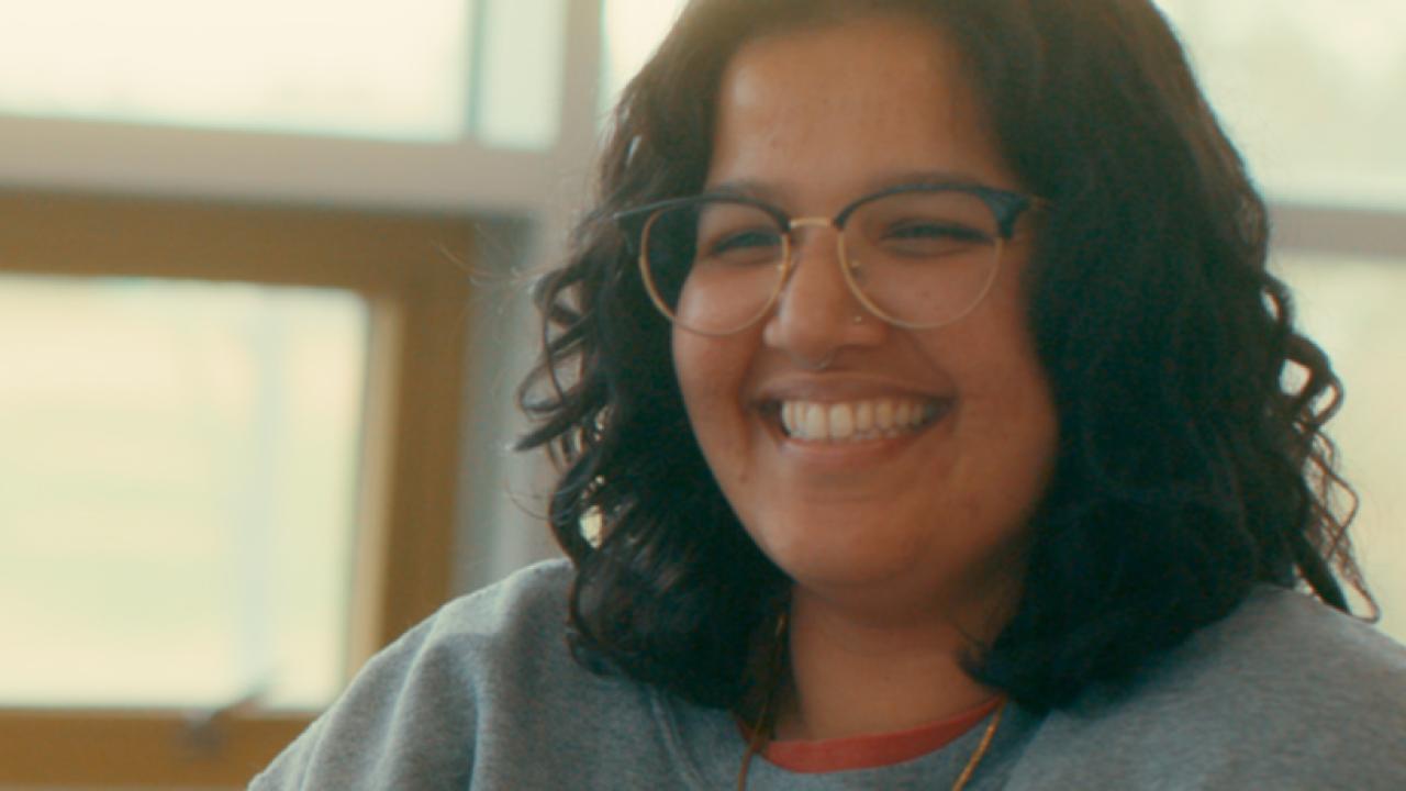 image of post-bac student smiling while talking to someone