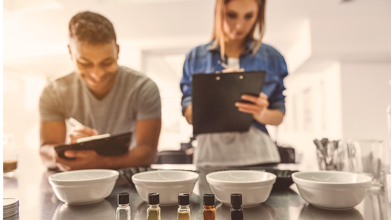 two people with clipboards prepare for a coffee making lesson