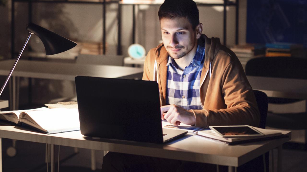 Man working at a laptop in his home office