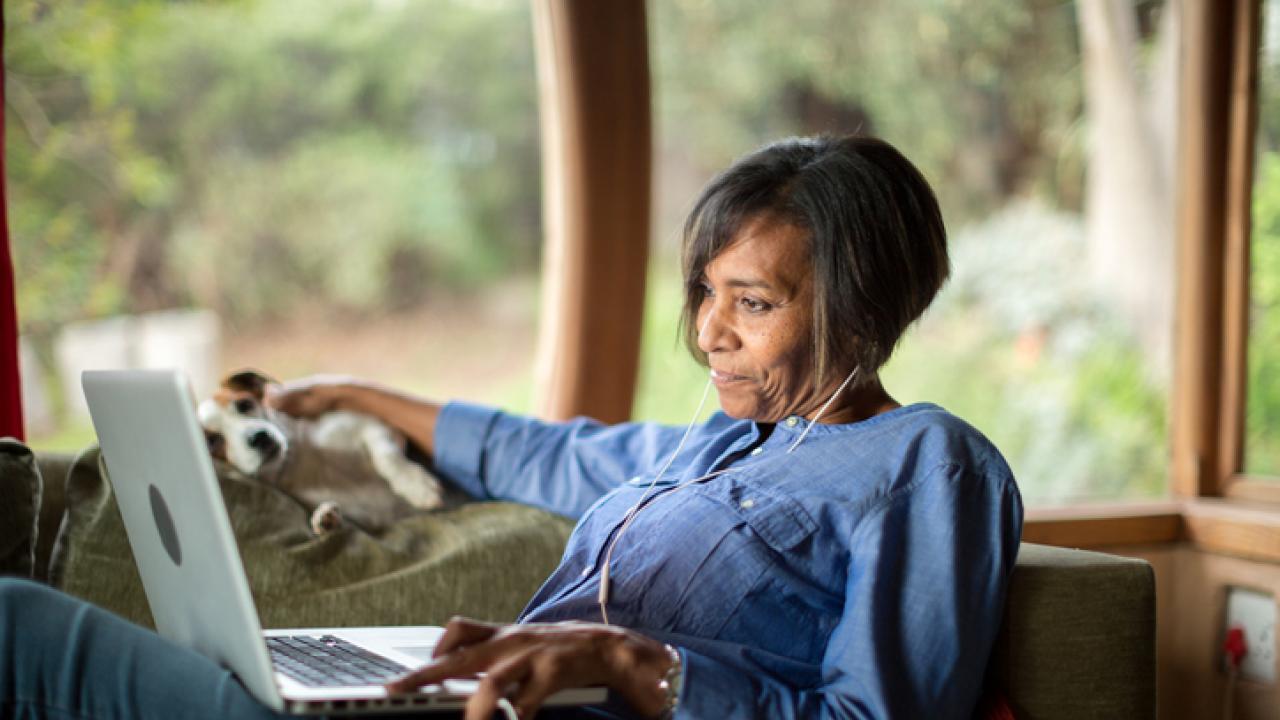 Woman on laptop with dog
