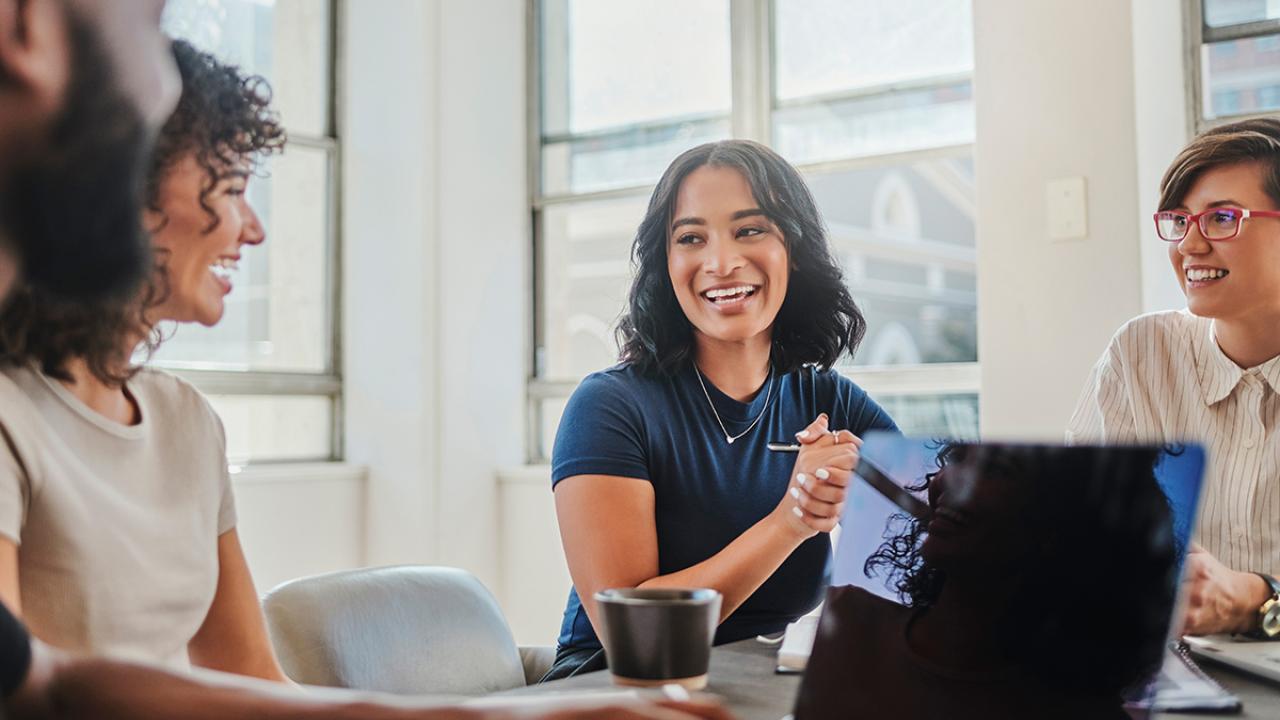Business meeting with a group of happy, smiling people at the table