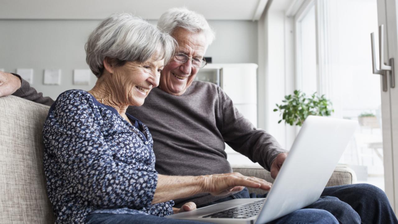 OLLI man and woman watching laptop