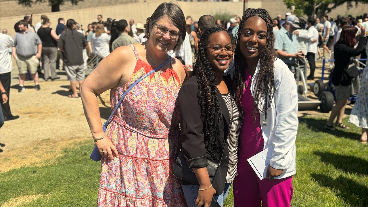 UC Davis health professions post-bac grad Kayla Hall poses with program advisors during her white coat ceremony