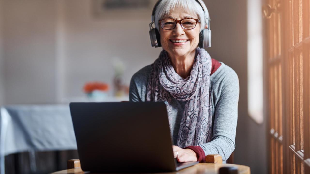 OLLI Woman on Laptop with Headphones on