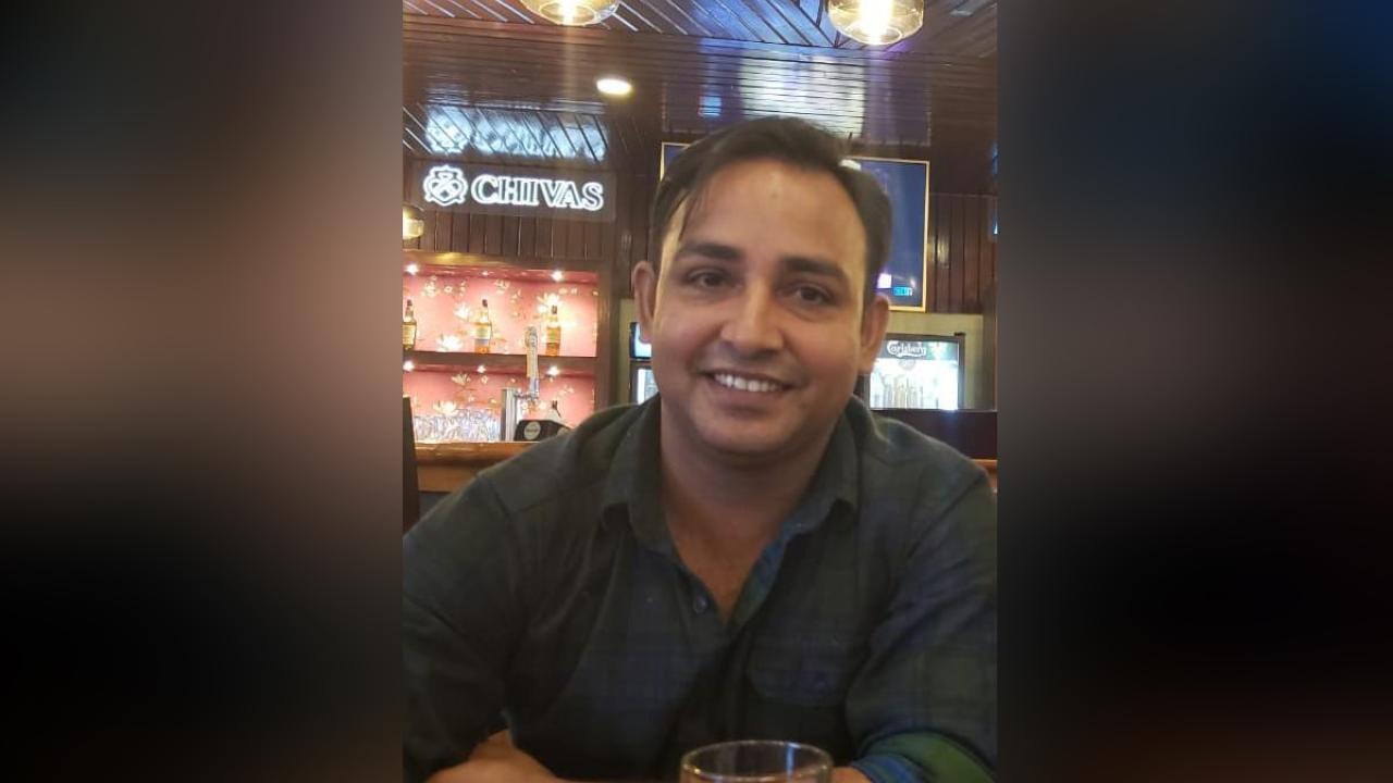 Rajesh, CPE project management student, smiles for the camera in a bar
