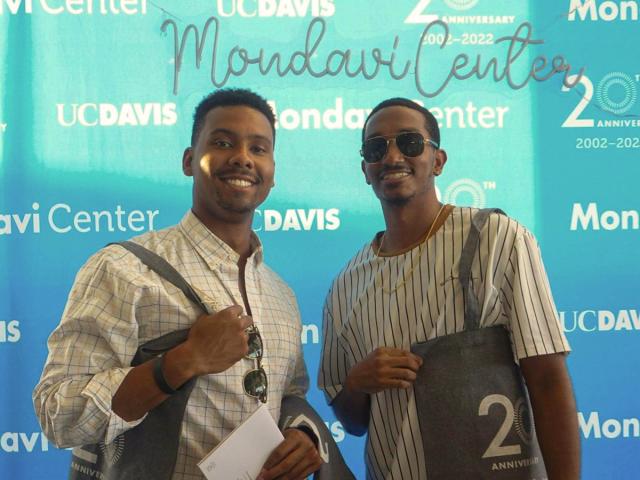 UC Davis Health Professions Post-Bac grad Adejia Boutte, Jr on the left stands with a friend at Mondavi