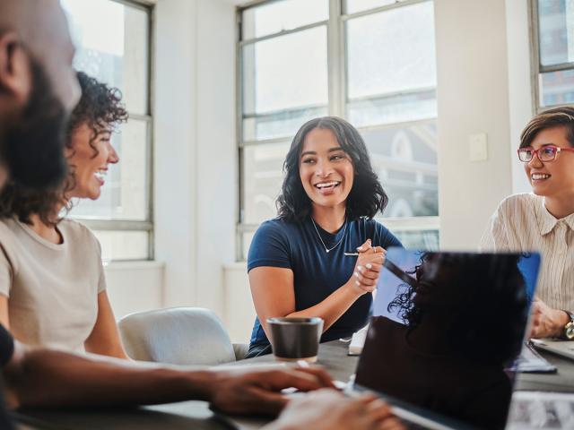 Business meeting with a group of happy, smiling people at the table