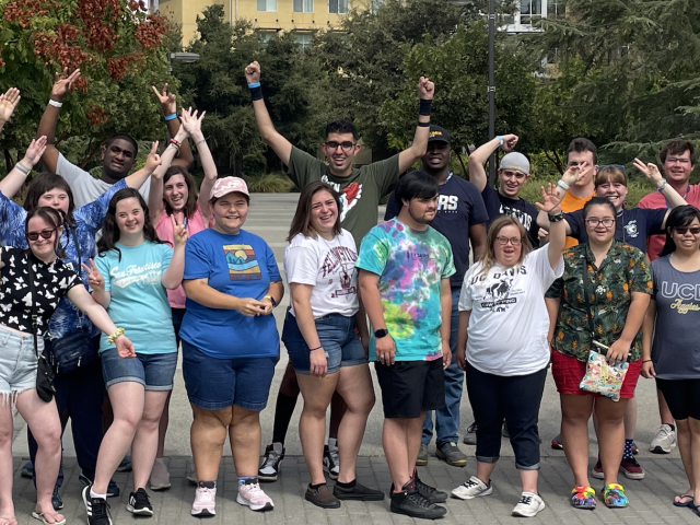 SEED scholars cheering and smiling on campus