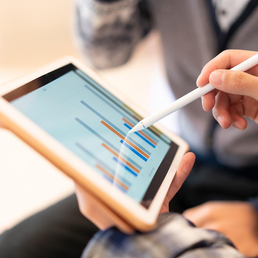 woman using a stylus on a computer tablet