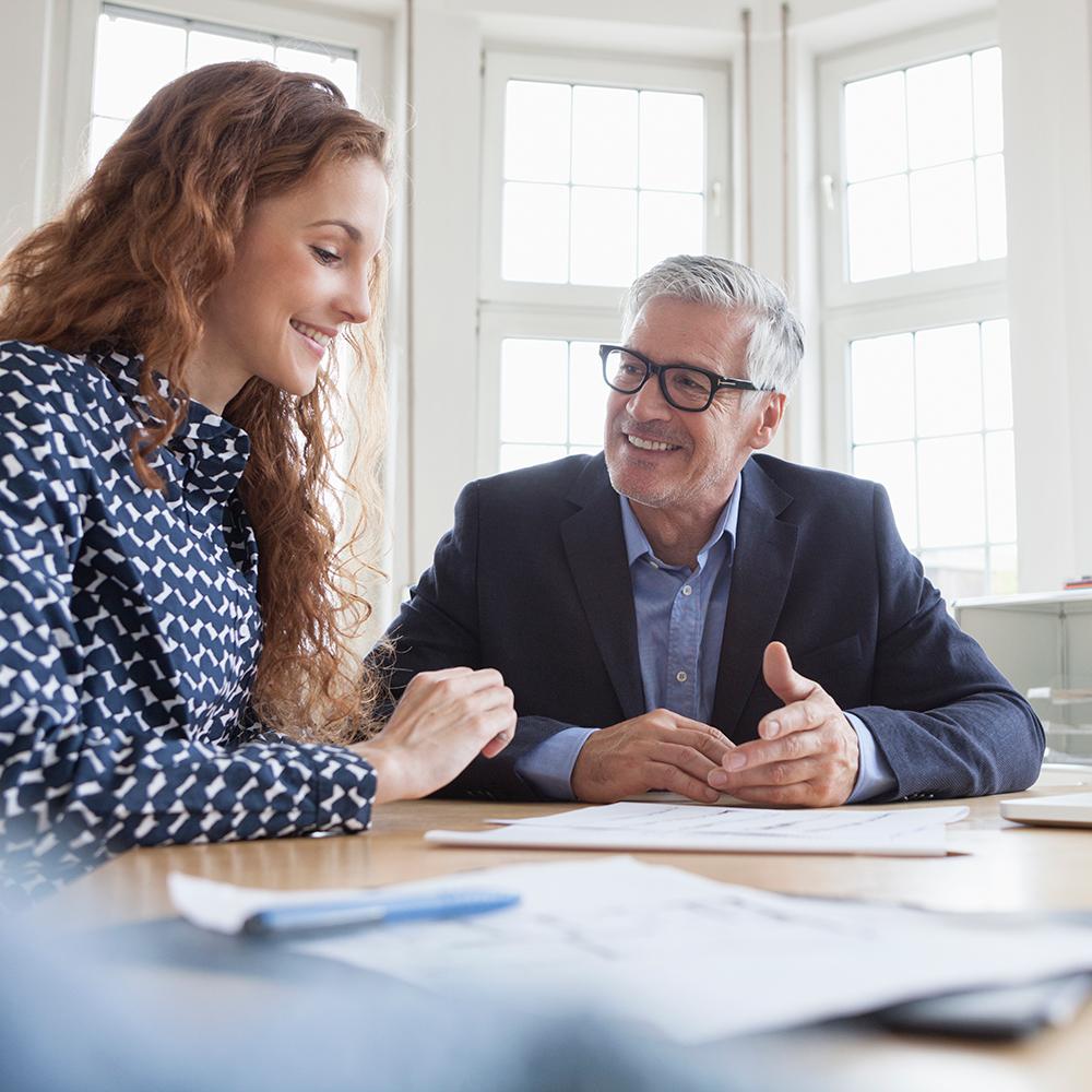 woman and man talking at a desk