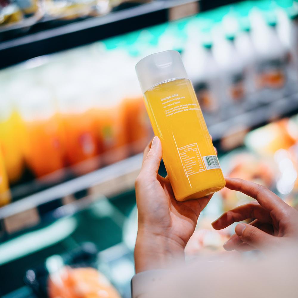 person examining ingredients on a cosmetics bottle