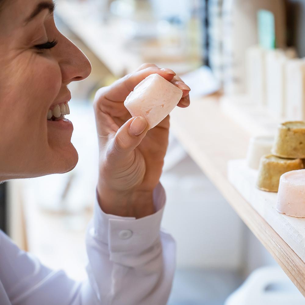 woman smelling scented candle