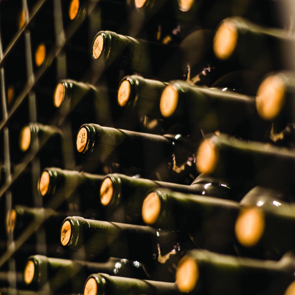 close up of wine bottles on shelf