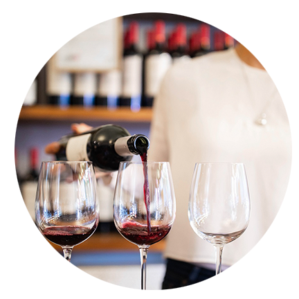 woman pouring wine for a tasting