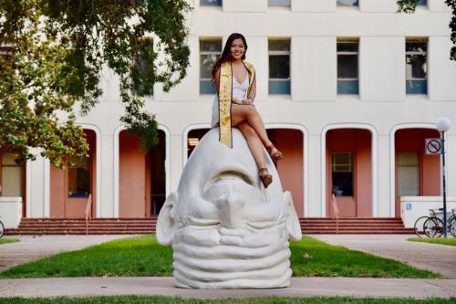 Tiffany Cha sits atop one of Robert Arneson's iconic Eggheads on the UC Davis Campus.
