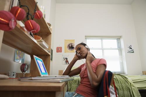girl in room with headphones on