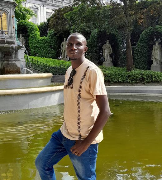 UC Davis Coursera student Theogene Semana poses in front of fountain in Bruxuels