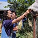 A UC Davis Pre-College student interacts with a horse during a lab at the Animal Science Horse Barn
