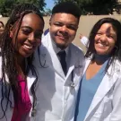 UC Davis Health Professions Post-bac grads Andre Brown, Matileen Cranick, Kayla Hall, Rachel Becker take a selfie in their white coat