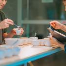 two baristas prepare for a coffee cupping tasting scope