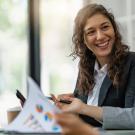 two business women talk to each other while looking at paperwork