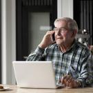 adult male senior on computer and phone