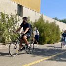 students riding bikes on campus