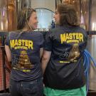 Two Master Brewers students show off their shirts at the brewery