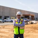 UC Davis Construction Management grad, Jon Davis, poses in front of a construction site