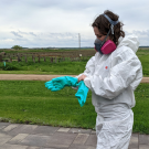 A woman wears proper PPE equipment fo use in ag health and safety