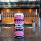 Hero shot of Tapping Potential Pink IPA can on a bar top