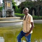 UC Davis Coursera student Theogene Semana poses in front of fountain in Bruxuels