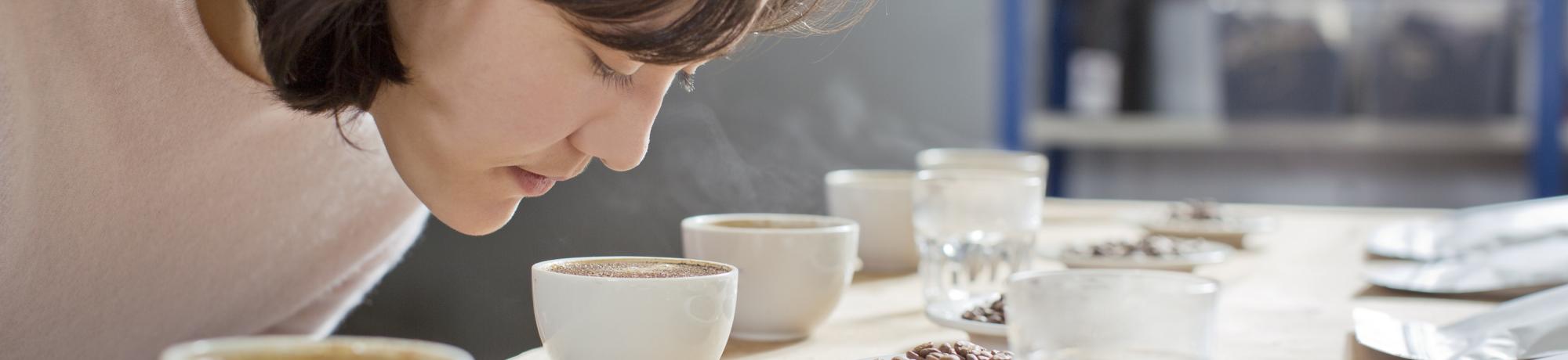 Woman smelling coffee