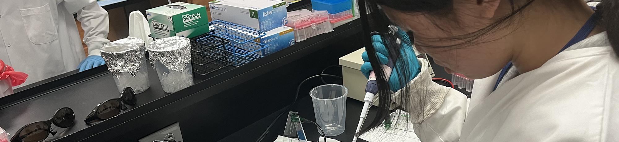 UC Davis Pre-College Program student pipetting in the Forensic lab