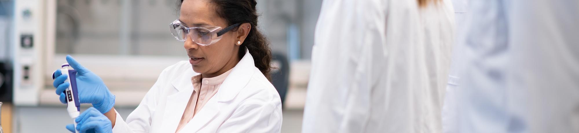 scientists in lab working with pipette